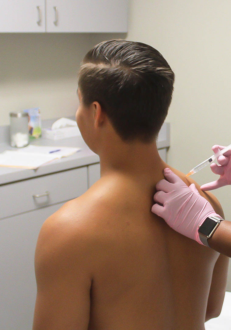 Doctor performing Advanced Joint Pain Relief injection on patient's sore joint