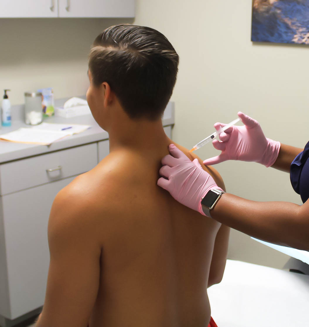 Doctor performing Advanced Joint Pain Relief injection on patient suffering with joint pain